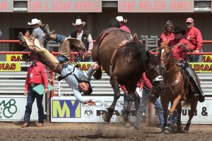 Bareback rider Kid Banuelos, captured mid-air as he's tossed from a bucking bronc, wears a huge smile!