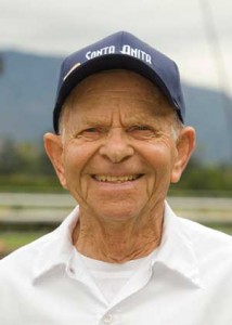 90-year-old John Shear poses in his Santa Anita Park baseball cap.