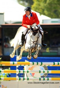 In his red coat, McLain Ward cuts a brilliant figure on the bright white horse Antares F.