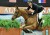 McLain Ward and his horse Rothchild jump a mock brick building at the Alltech National Horse Show.