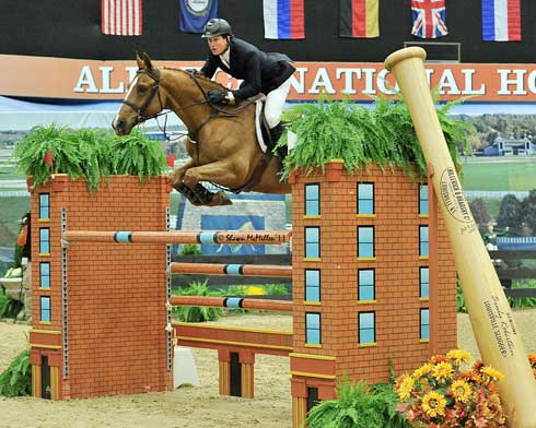 McLain Ward and his horse Rothchild jump a mock brick building at the Alltech National Horse Show.