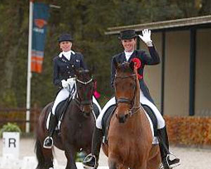 Australian riders Lyndal Oatley on Potifar and Mary Hanna on Sancette wave with pride as they take their "honor lap" at the Olympic qualifier.