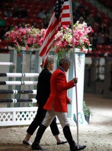 Melissa Brandes and Will Simpson, wearing his red team USA blazer, carry the flag at the opening ceremonies.