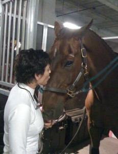 Grand prix rider Francie Steinwedell-Carvin kisses her horse Taunus goodnight after he is safely tucked in his stall.