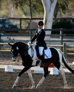 Maxance McManamy rides the dressage test on her flashy black-and-white pinto Trakehner, Project Runway.