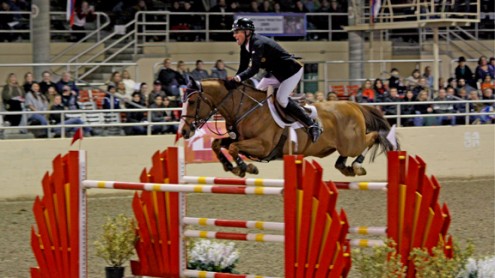 Rich Fellers and Flexible, 2011 L.A. National Grand Prix Rich Fellers and his fiery chestnut horse Flexible fly over an orange jump.