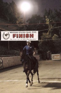 Jeremy Reynolds and Riverwatch gallop beneath the "Finish" sign to win the 2011 Tevis Cup Endurance Ride.