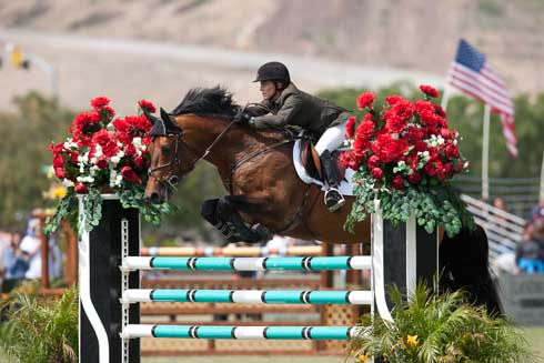 Rider Susan Hutchison and her horse Cantano sail over a jump in San Juan Capistrano.