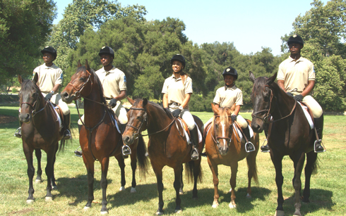 Compton Jr. Posse junior ranger graduating class on horseback in the park.