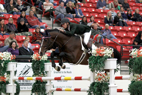 Karl Cook and Johkheer Z fly over a jump at the Las Vegas National Grand Prix.