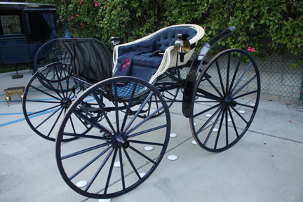 Light, two-person phaeton in blue, black and cream.