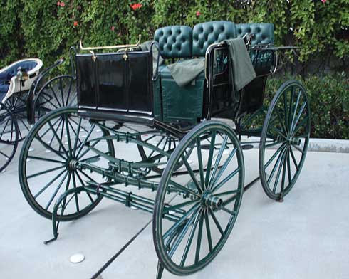 Green leather accents the utilitarian "Trap" carriage.