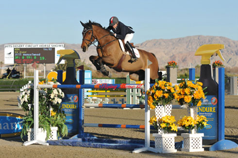 Jill Henselwood and IV soar over a jump.