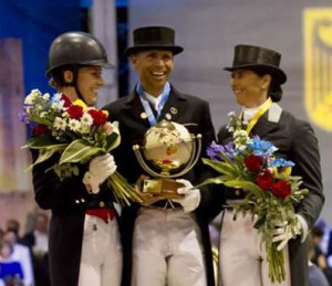 Dujardin, Peters and Vilhelmson-Silfvén hold flowers and trophies on the podium at the World Dressage Masters.