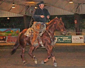 Mark Matson rides his red pony at a fast canter.