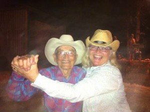 Bert Bonnett and Becky Borquez dancing in cowboy hats.