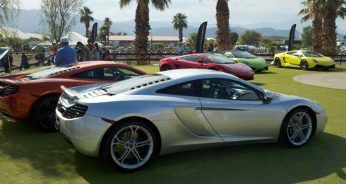 Colorful Lamborghinis on a lush green lawn.