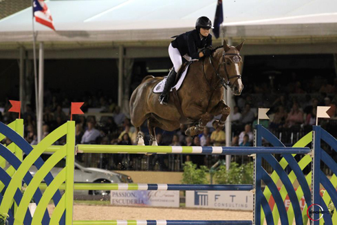 Reed Kessler and the bay mare Cylana clear a vertical jump.