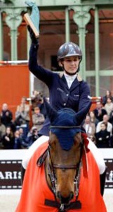 Ukrainian rider Katharina Offel hoists her trophy above her head.