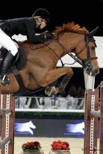 Edwina Tops-Alexander and her red horse soar over a jump.