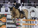 Edwina Tops-Alexander pilots her small chestnut gelding over an oxer.