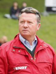 German dressage coach Holger Schmezer looking dapper in a red jacket.