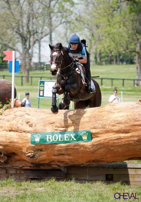 Barb Crabo and her horse clear the Rolex log on the cross country course.