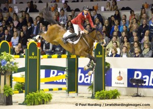 Richard Spooner catches air as his horse clears a huge oxer.