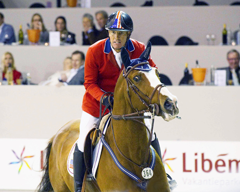 Close-up of Rich Fellers and Flexible on course at the 2012 Rolex World Cup show the whites of the horse's eyes.