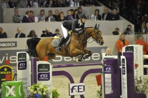 Swiss rider Steve Guerdat and Nino show textbook form over a jump.