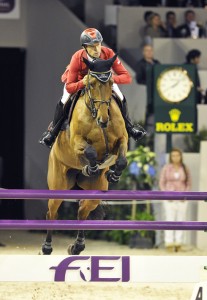 Pius Schwizer and Carlina appear to jump into the camera as they clear a vertical.