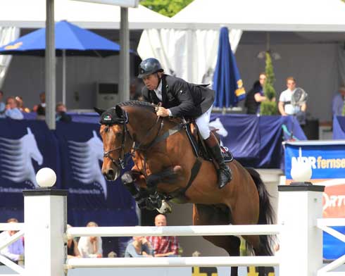 Nick Skelton and Big Star soar over a jump.