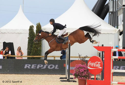 Richar Spooner and Cristallo leap over a vertical on course in Spain.