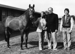 Black and white image of John and Tish Quirk standing with a beautiful Irish horse.