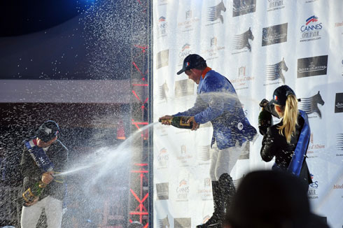 Top 3 at the GCT Cannes spray each other with champagne on the awards podium.