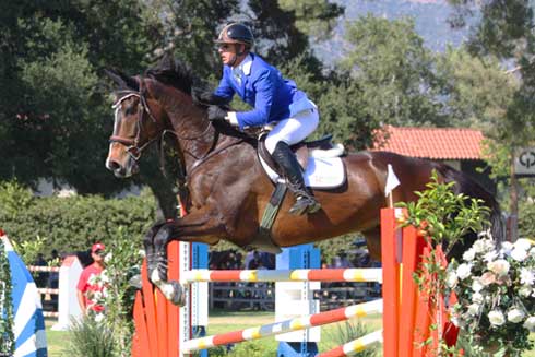 Lane Clarke cuts a striking figure in his royal blue jacket aboard the bay jumper McLord's First John.