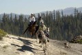 Tevis_trail-riders. Three trail riders clear a ridge in the Lake Tahoe mountains.