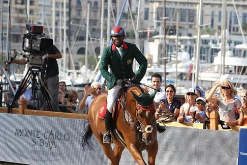 Moroccan rider Abdelkebir Ouaddar rides against a backdrop of yachts in Monaco.