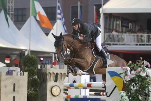 Kevin Staut clears a jump with his bay horse at the GCT.