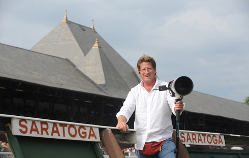 Michael J. Marten poses with his camera in front of the steeples at the Saratoga race track.