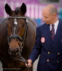 Steffen Peters leads a bridled but saddleless Ravel.