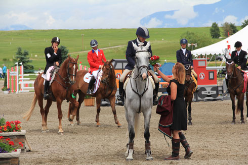 Krist Nunnink and R-Star accept their first place honors, including a bouquet of red roses.