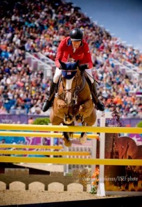 Rich Fellers and Flexible fly over a yellow jump.