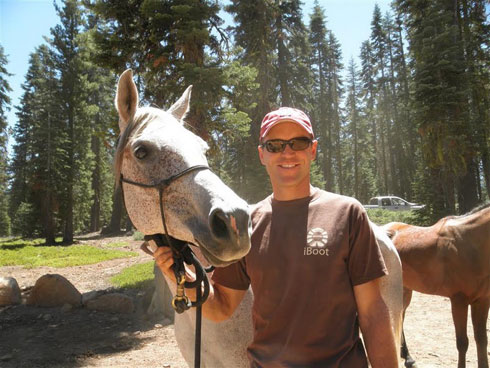 Garrett Ford poses with his grey horse The Fury