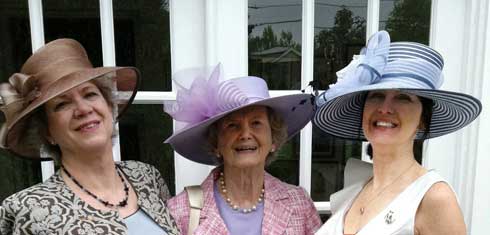 Kate Tweedy, Penny Chenery and Leeanne Meadows Ladin pose in elaborate hats.