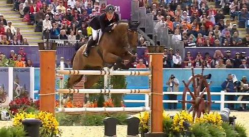 Scott Brash and Hello Sanctos clear a nautically-themed jump decorated with ships' wheels.