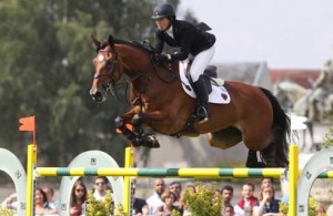 Beezie Madden and Simon clear a jump.