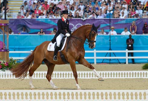 Laura Bechtolsheimver and Mistral Hojris perform a collected canter.