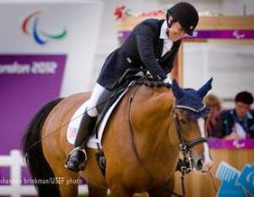 Donna Ponessa gives her horse a pat after their round.