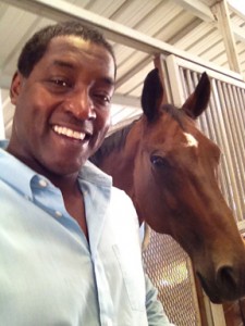 Philip Atwell poses with a horse at his barn.